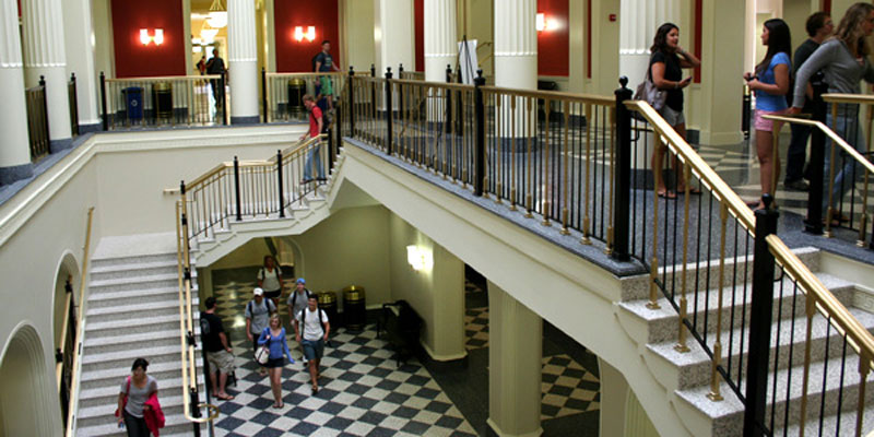 Farmer School of Business lobby and staircase, students walking to class and talking in the hall