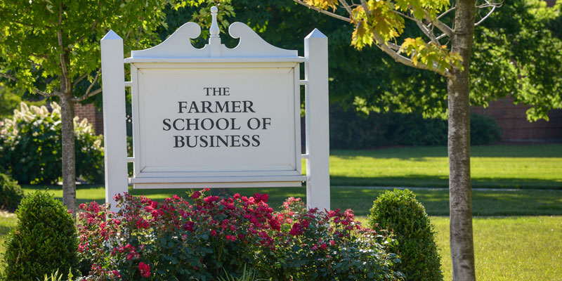 White Farmer School of Business sign in flowerbed