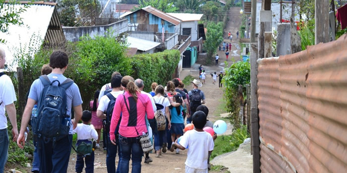 Students walk through third world village