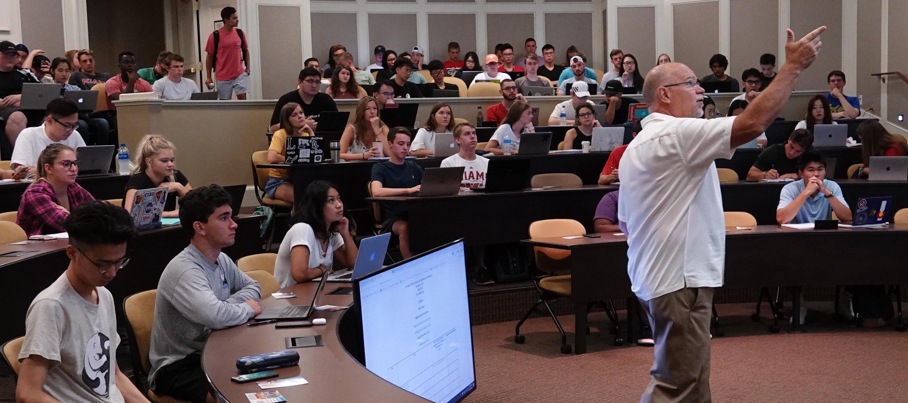 Instructor gestures toward the screen during the first day of classes