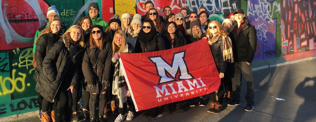 Students pose with Miami flag in Berlin
