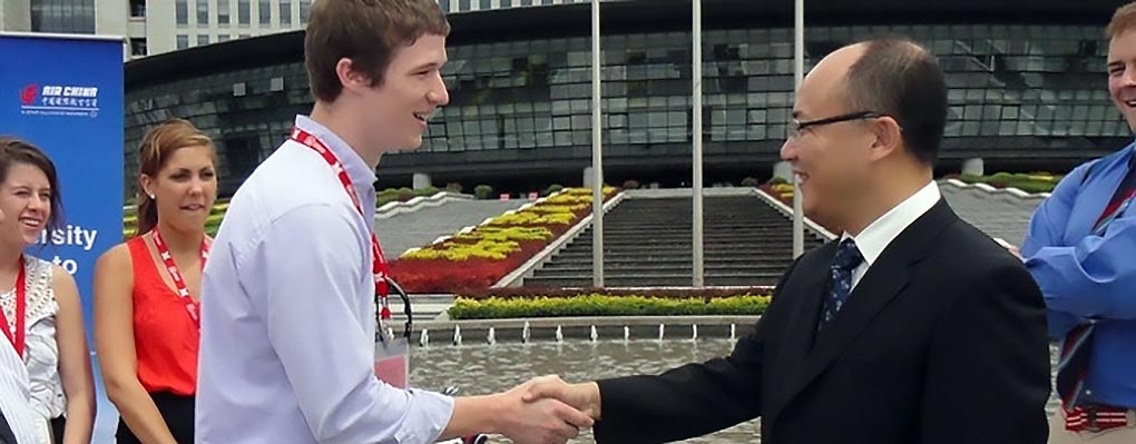 Student shakes Chinese man's hand
