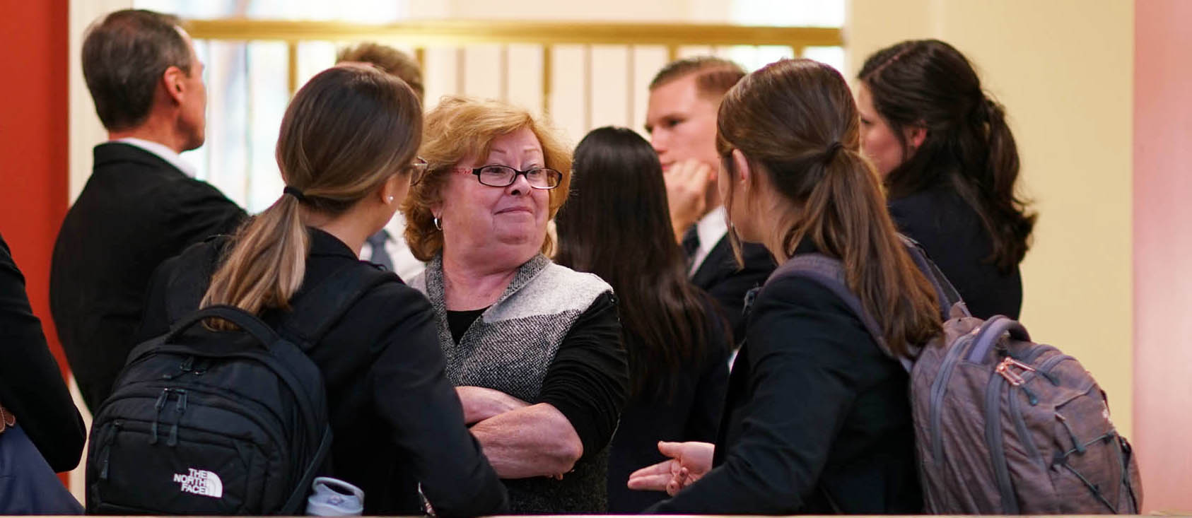  Students surround Jan Taylor after their first round in the West Monroe Partners case competition