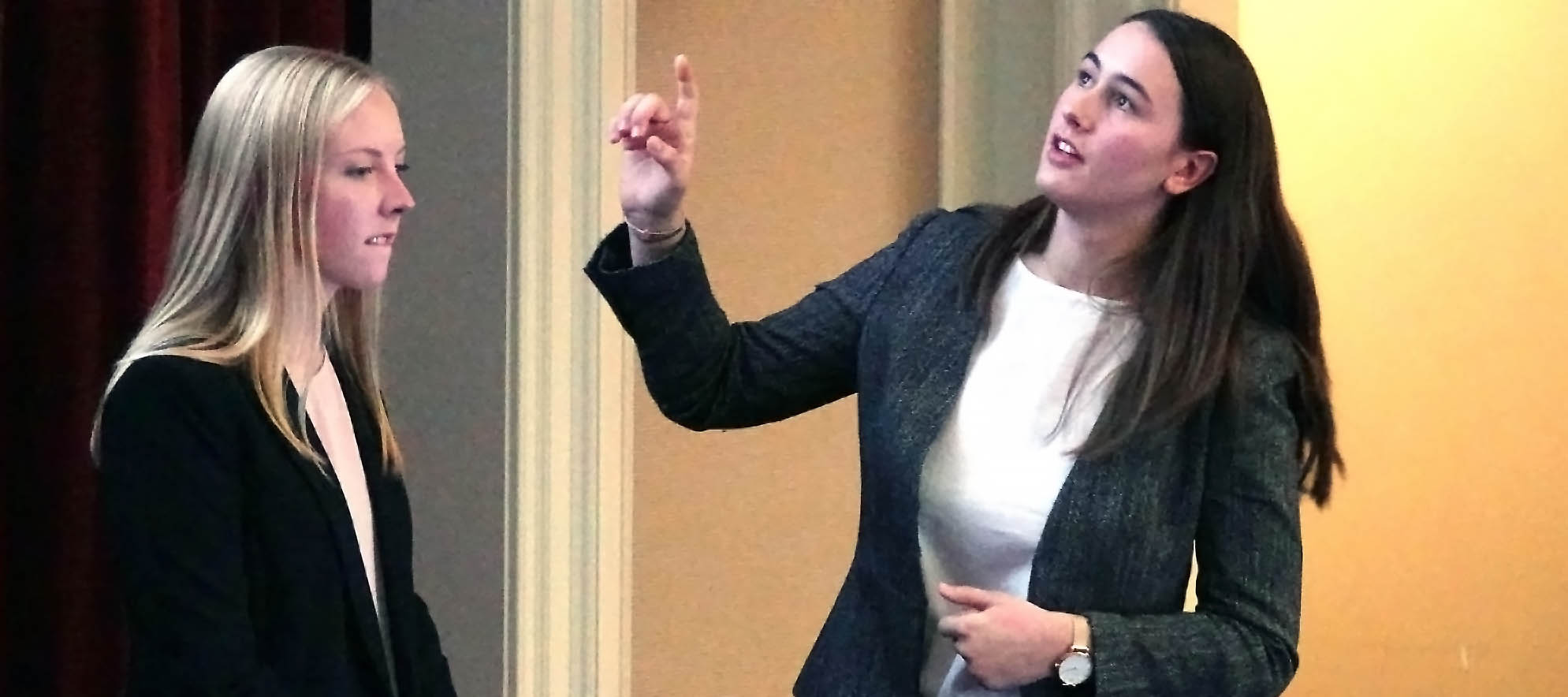  Student points to next slide in presentation at West Monroe Partners case competition