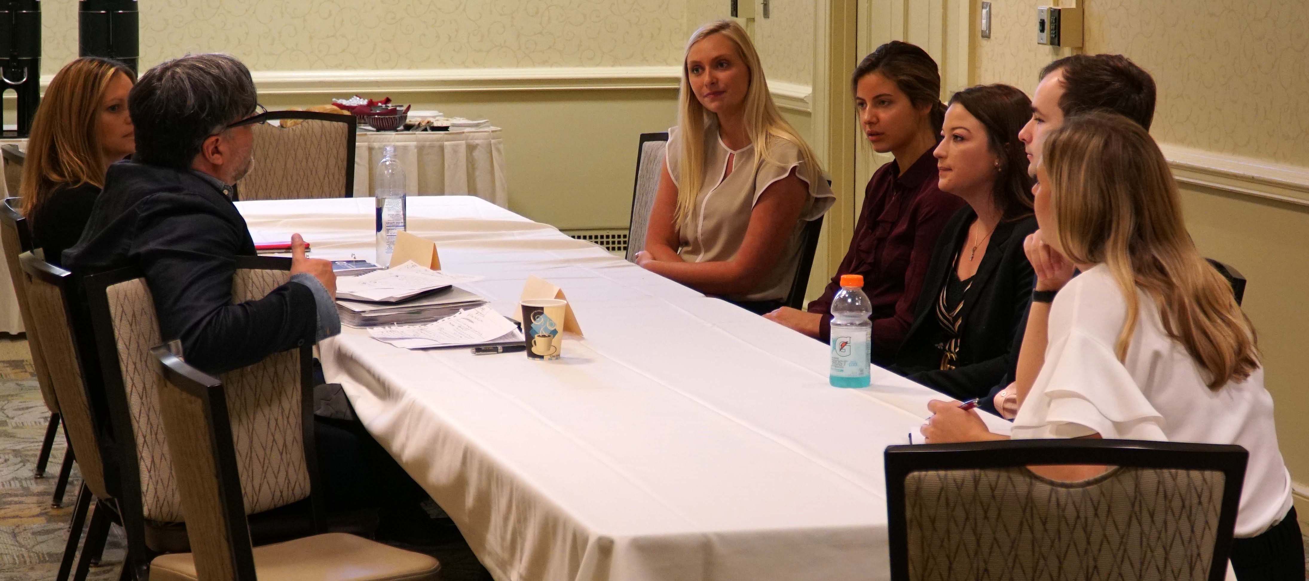 Students talk with Harman executives during Strategy Works