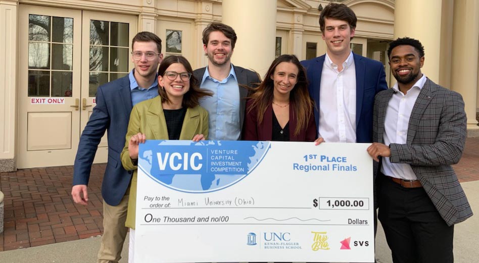 Members of VCIC team pose with big check