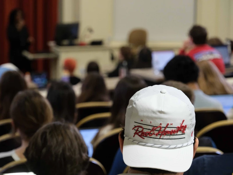 students sitting at table with laptops outside of Farmer School of Business