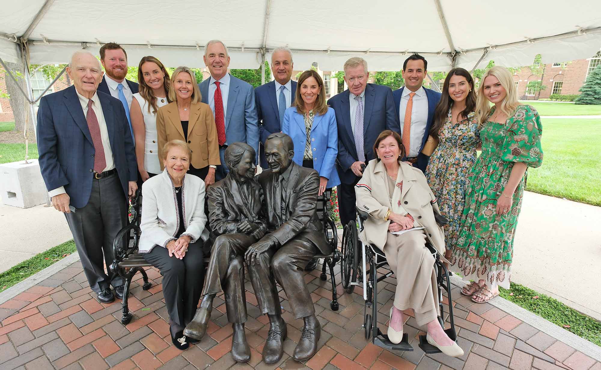 Farmer Family and friends around sculpture
