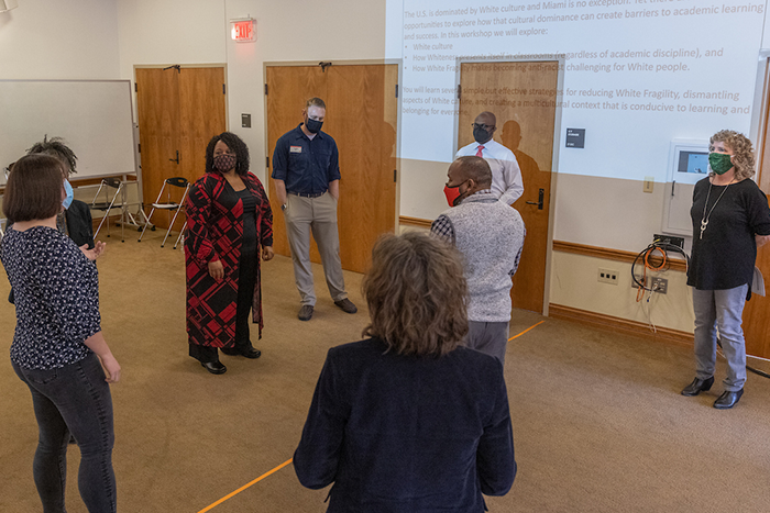 A group of Miami staff and faculty participate in a workshop exercise