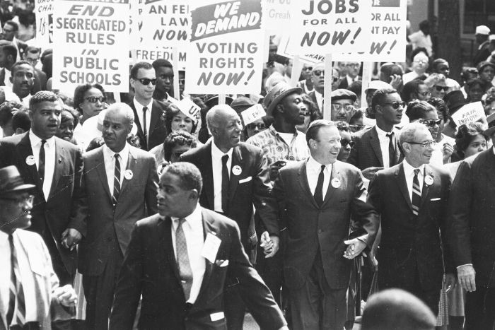 group of people marching with signs