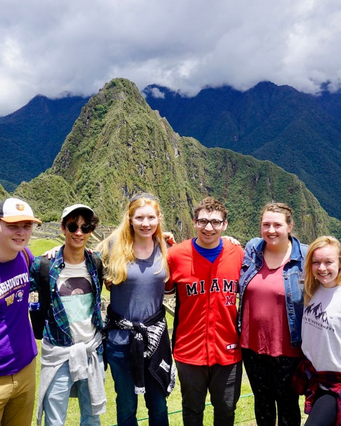 Miami students standing in front of Machu Picchu in Peru