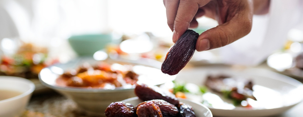 Middle Eastern Suhoor or Iftar meal, hand grabbing dates