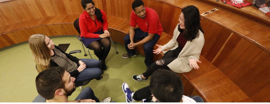 group discussion between Miami staff, faculty, and students; smiles; sitting in circle
