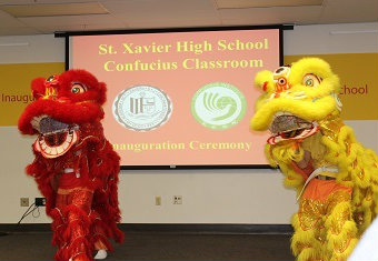 Performance by students at St. Xavier High School in colorful costumes, presenting the new Confucius Institute classroom.