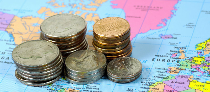 American coins sitting on a map