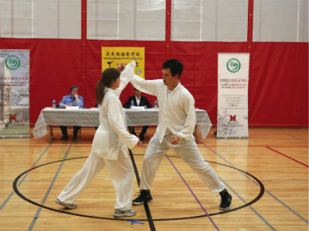 Self defense pair competing in front of judges