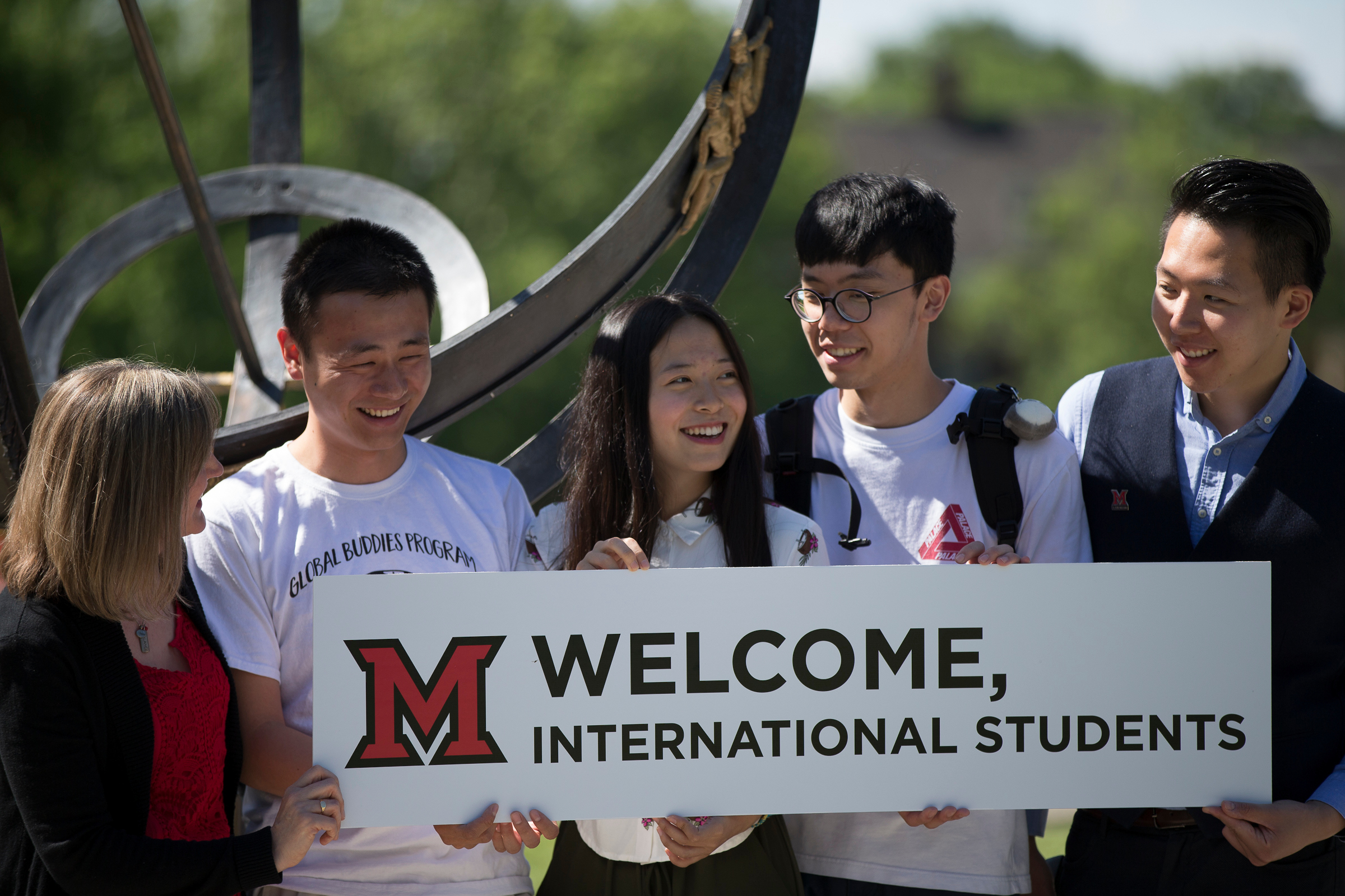 Miami University students and staff holding Welcome, International Students sign