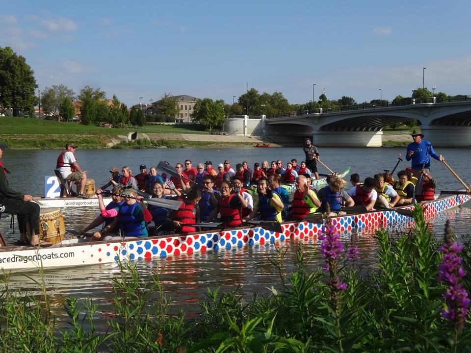 Participants of the Dragon Boat Festival row down the river.