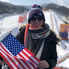 Catie holding an American flag at the Olympics