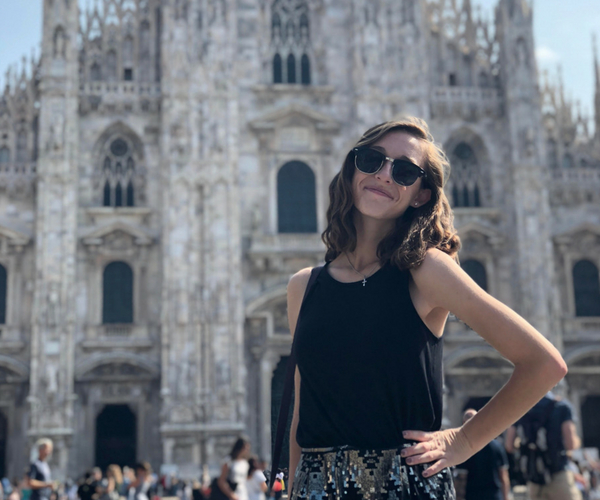 Student posing in front of a church in Milan