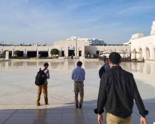  photo of Miami students studying abroad in the Middle East, they are walking toward a building