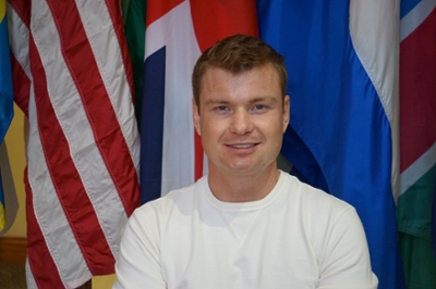 Heath poses in front of flags