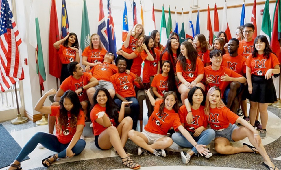 Student organization poses in front of international country flags
