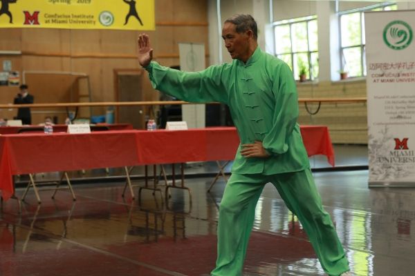 man in green uniform practicing martial arts