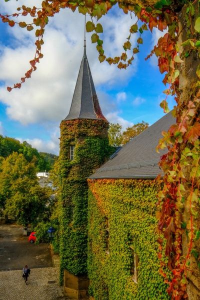 MUDEC Chateau in Differdange, Luxembourg, blue skies and ivy on castle