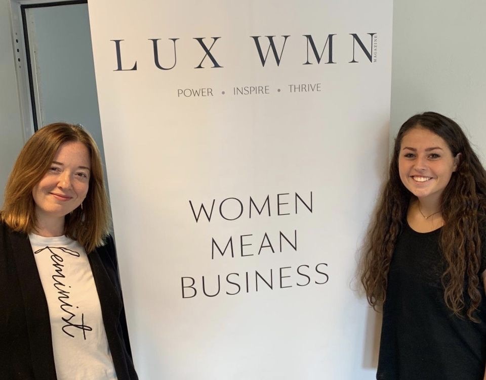Amanda Roberts and Alex Faiello with the LUX WMN banner