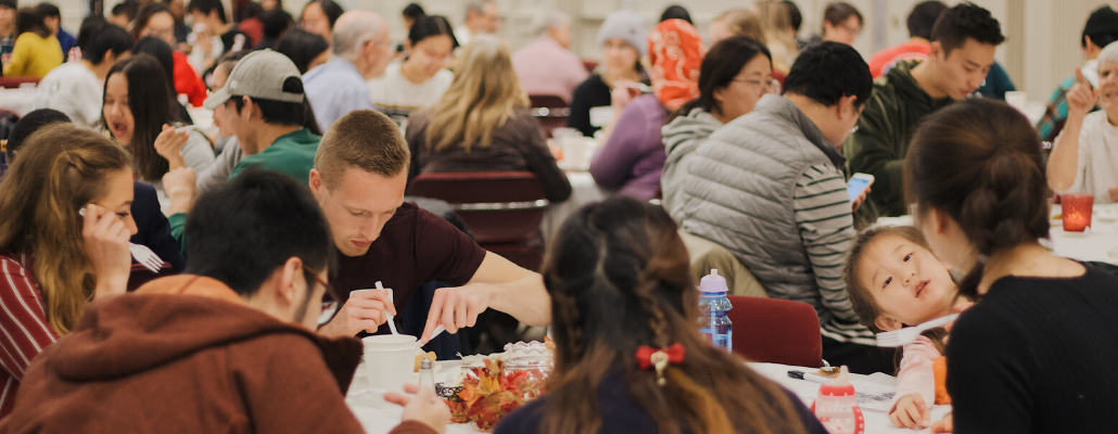 students, faculty, and community members gather in the Shriver Center to eat a Thanksgiving dinner