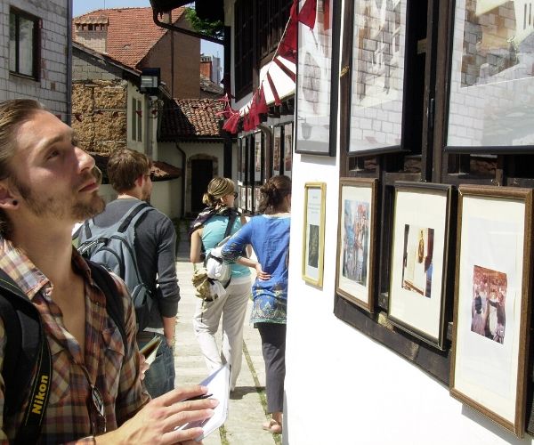 student looking at artwork on the streets of Kosovo