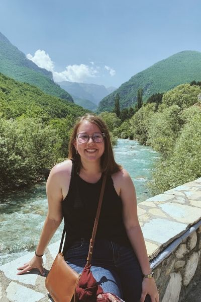 Elyse Legeay smiling in front of a body of water