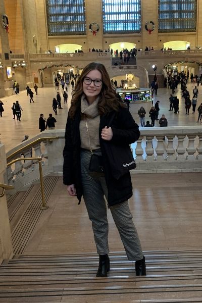 Miranda Oates takes a photo in the train station in New York