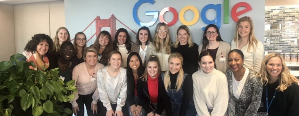 a group of students pose in front of the Google sign