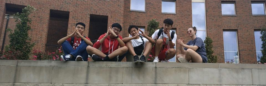 Tenen and his friends sitting on a ledge