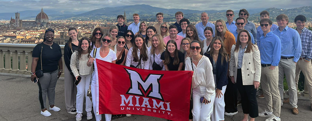 Miami M flag and students in Florence, Italy, Summer 2021