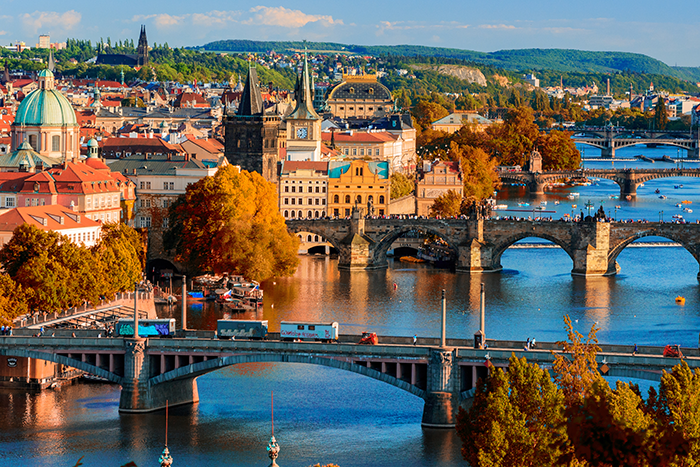 View of the Vltava River and Charle bridge with red foliage, Prague, Czech Republic