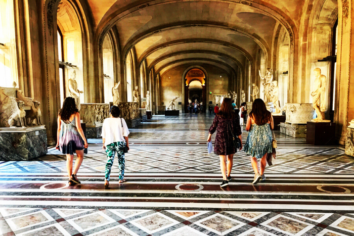 students walking through the Louvre in Paris