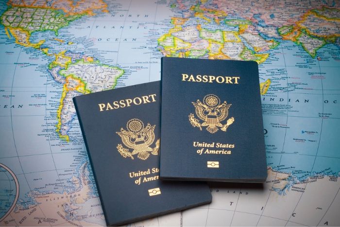 two US passports on top of a map