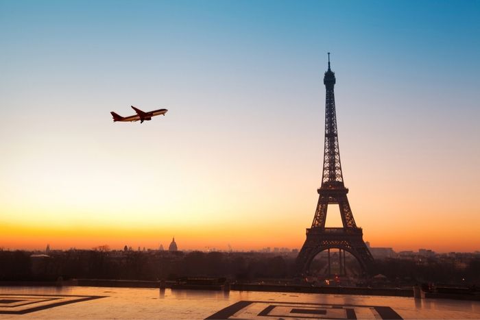 plane flying in Paris near Eiffel Tower