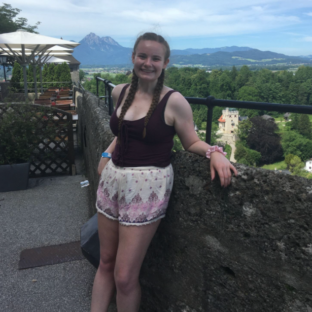 Hannah poses on a balcony in Europe