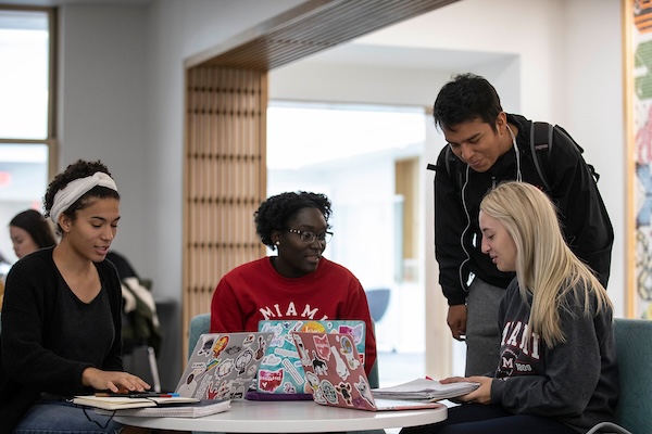 students at a table in discussion
