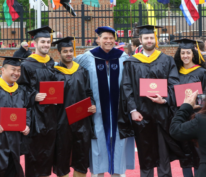  Group of Master's students with a professor at May Commencement