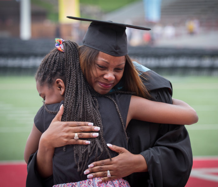  A recent graduate hugging her daughter at graduation