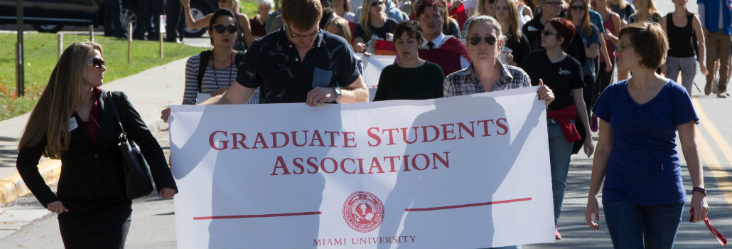  Group of students holding the Graduate Student Association banner