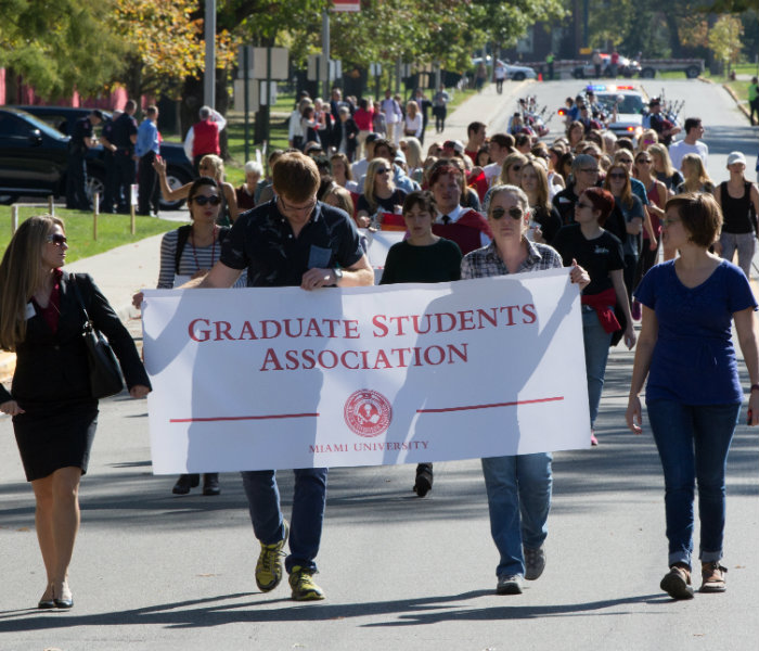  Group of students holding the Graduate Student Association banner