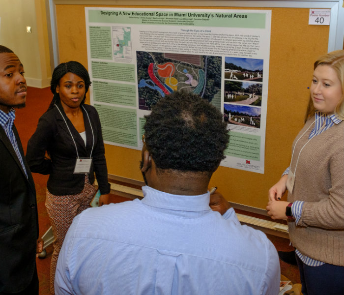  Group of environmental science students present their research to a judge