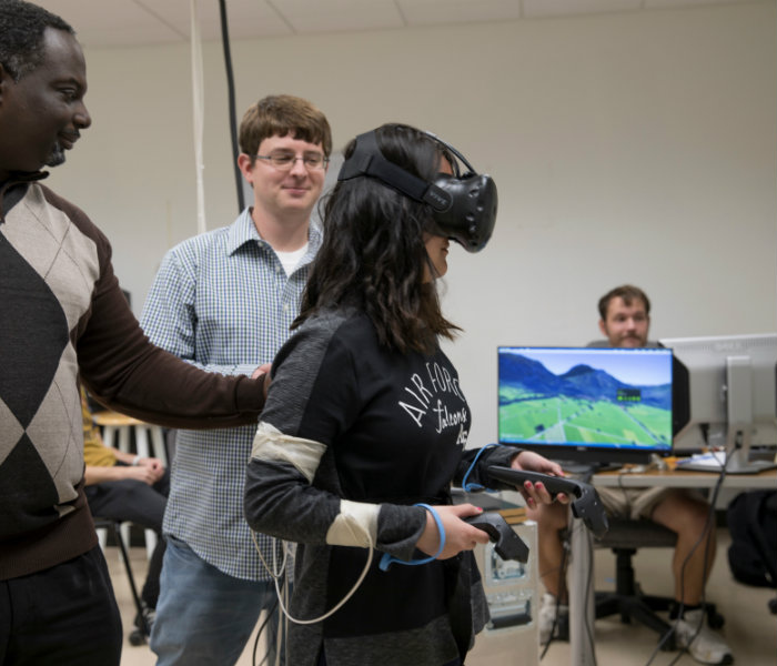  Student wearing a virtual reality simulator conducting an experiment