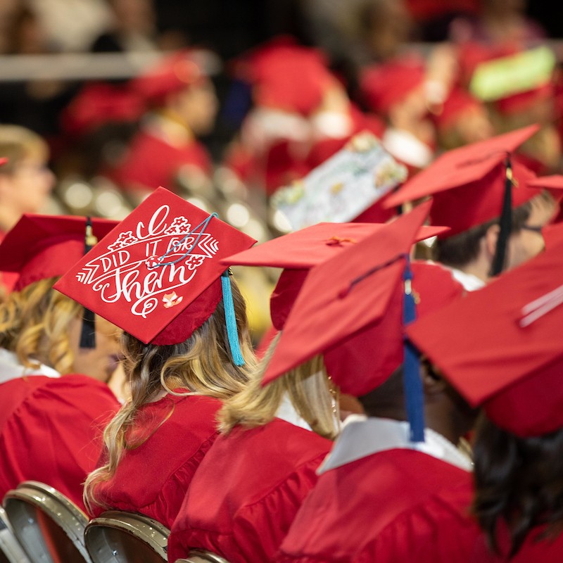 Back view of graduation caps during ceremony
